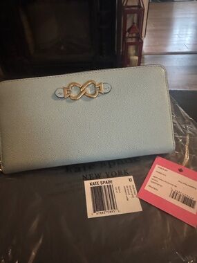 kate spade light blue pebbled leather zip wallet with gold emblem